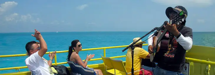 isla mujeres ferry tourists live musician ocean