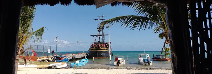 puerto juarez cancun mexico beach restaurant pirate ship fishing boats ocean