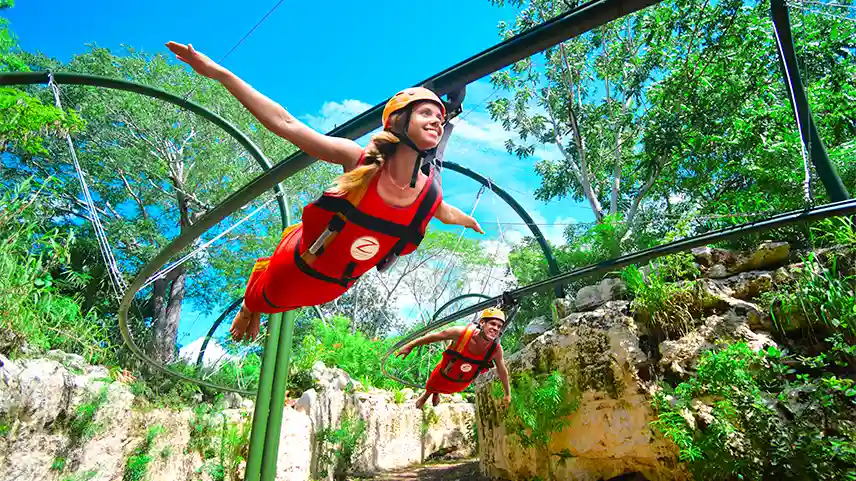 Woman and man flying on a Riviera
Maya zipline over the Xenses park, surrounded by ancient natural stone walls, caves, and lush rainforest.